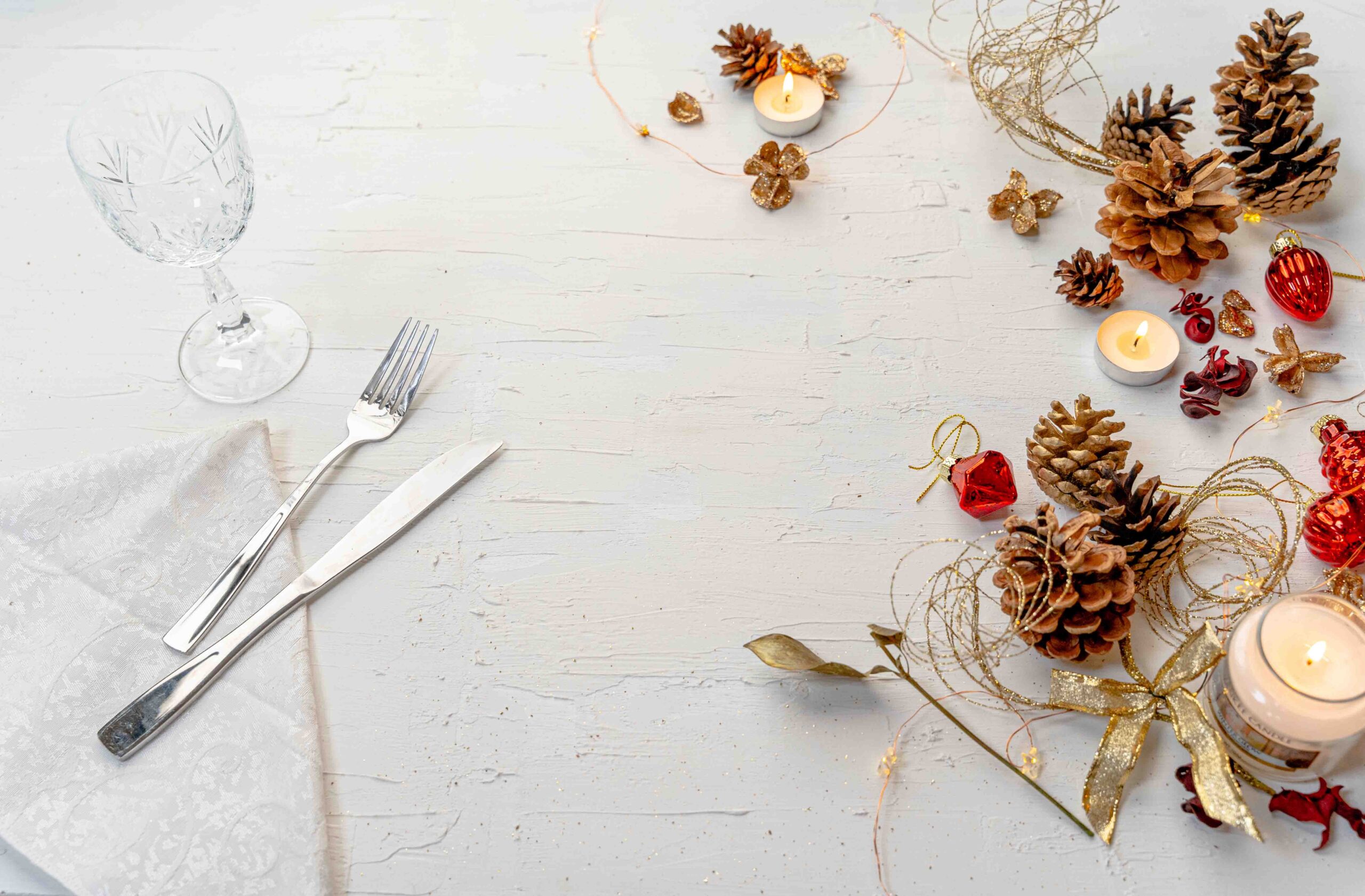 Overhead shot of a rustic colorful Christmas dining table with decors and space for text